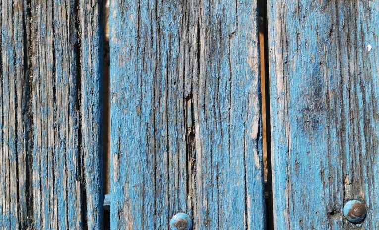 Old peeling paint being removed from wood