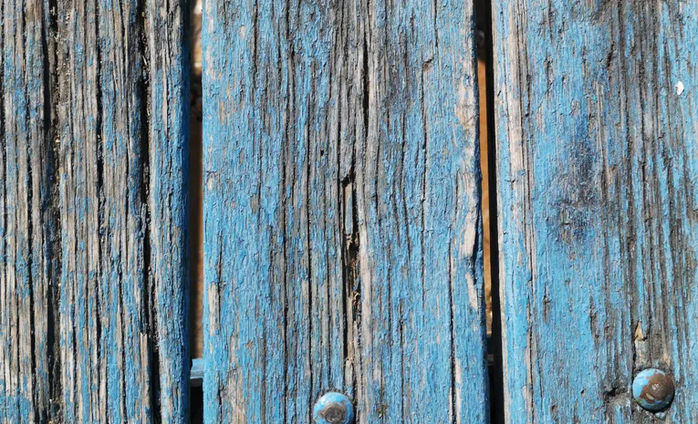 Old peeling paint being removed from wood