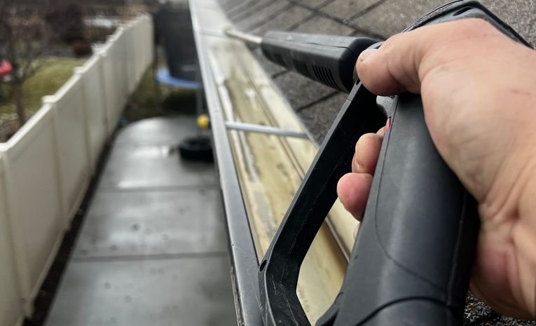 Professional roof and gutter cleaning removing moss