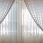 Modern eyelet curtains hanging in a bright room