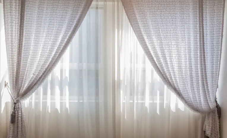Modern eyelet curtains hanging in a bright room