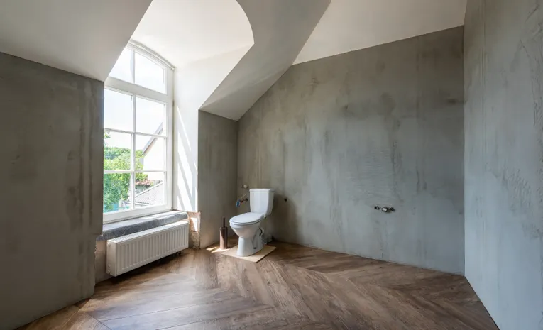 Modern white toilet and bidet fixture in a bathroom